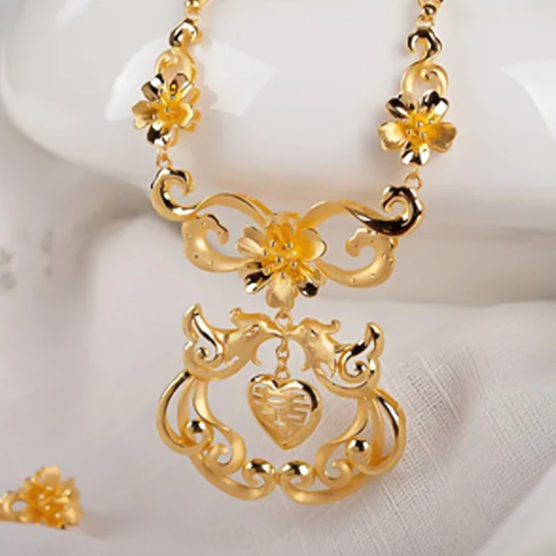 Gold-tone necklace with an ornamental openwork pendant