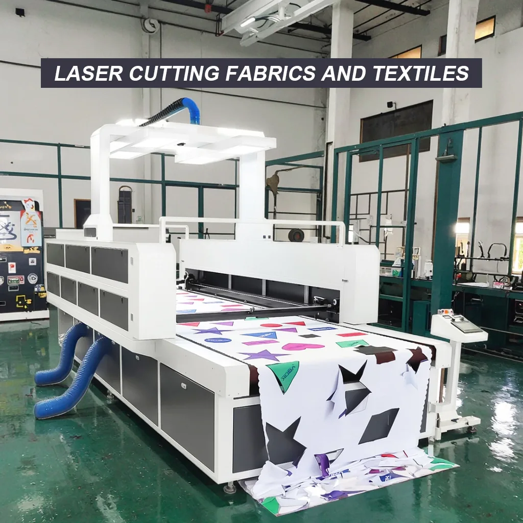 Fabric laser cutter feeding printed material on a conveyor table