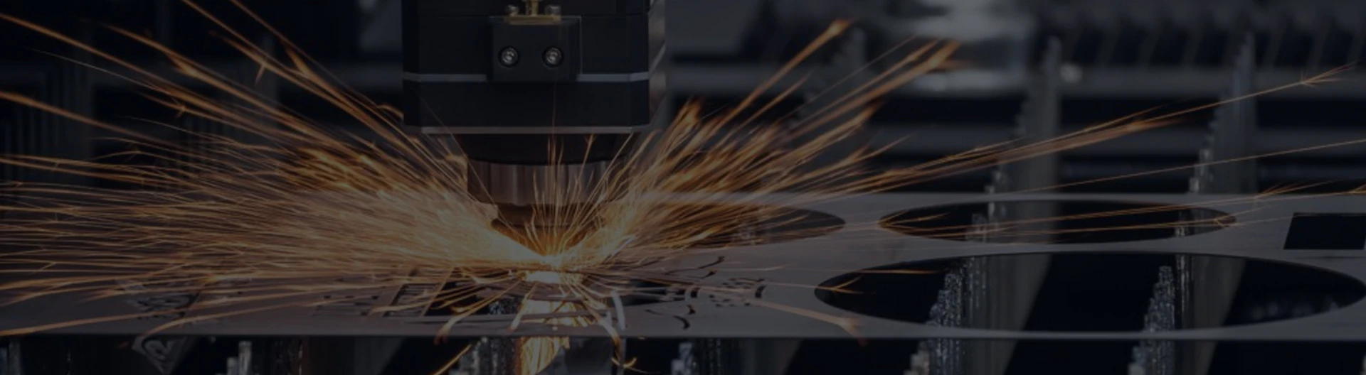 Sparks at the cutting head during laser cutting of a metal sheet