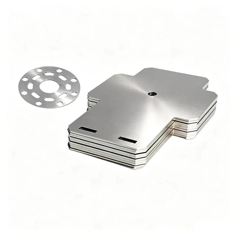 Stacked sheet metal plates with cut holes and slots beside a perforated disc