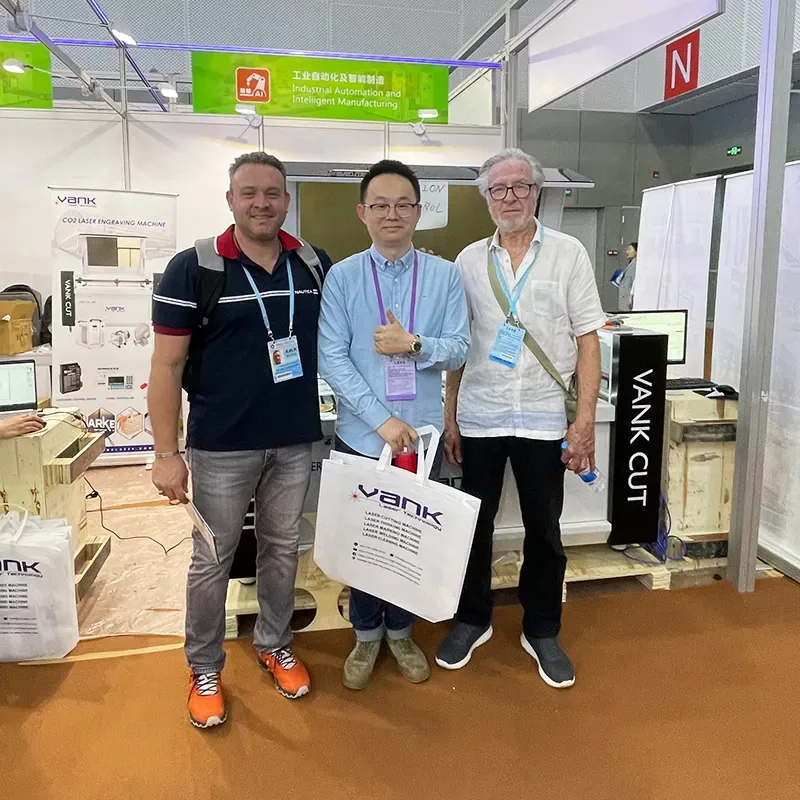 Visitors beside laser equipment at the Vank Laser booth, Canton Fair 2023 in Guangzhou.